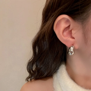 Minimalist silver polished C-shaped droplet earrings for women with a metallic glossy finish