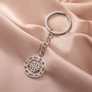 Stainless steel witch's knot moon keychain with mystical charms on pink silk