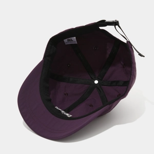 Detail view of purple baseball cap interior with reinforced seams and adjustable strap