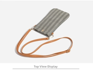 Detailed top view of a woven straw phone bag featuring black and white herringbone pattern