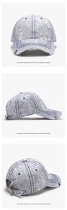 Detail view of washed denim baseball cap with vintage distressed holes and metal buckle