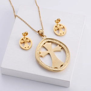 Three-piece gold titanium steel jewelry set featuring brushed cross pendant and earrings