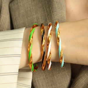 Set of four colorful enamel twisted metal bracelets in green, black, white and blue