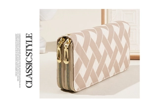 Detail of white striped long wallet featuring dual metal zippers and classic style text