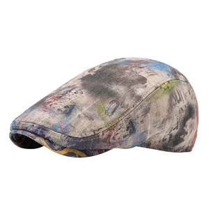 Artistic tie-dye cotton linen beret with colorful graffiti print in minimalist white background