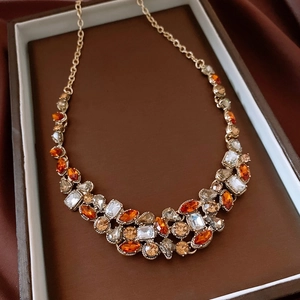 Detailed macro view of vintage gold necklace with amber waterdrop crystals and gems