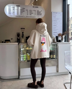 Detail of oversized cream hoodie with a cartoon duck and funny slogan on the back