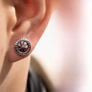 Macro shot of retro stainless steel cartilage stud with hollow octagonal star pattern