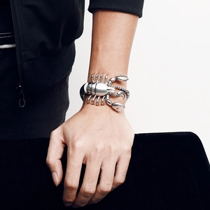 Street style silver titanium steel scorpion bracelet worn by a male model