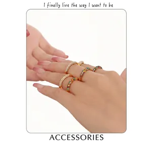 Detailed view of layered 18K gold plated rings set with vibrant multi-colored zircons