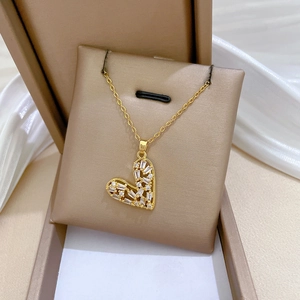 Close-up of gold heart pendant with sparkling cubic zirconia in a jewelry box