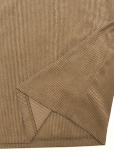 Close-up of brown corduroy fabric showing detailed vertical ribbed texture and soft drape