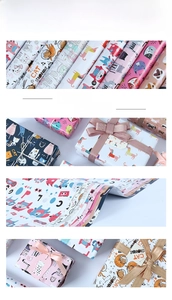 Detail of colorful cartoon kitten and astronaut gift wrapping paper with ribbons