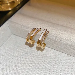 Elegant gold C-shaped double-layer earrings with white inlay and zircon accents