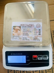 Detailed view of Santa Claus license card showing weight at 6g on digital scale