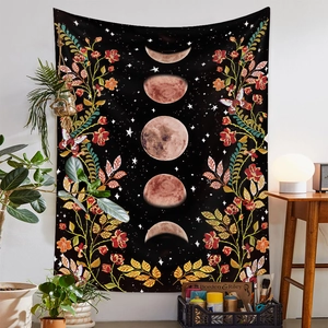 Detailed view of bohemian moon phase tapestry with flowers and butterflies in a home setting