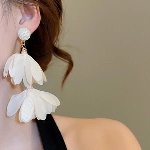 Detailed view of elegant white chiffon flower drop earrings with a spiral textured stud