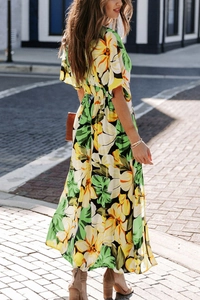 Detail view of high waist floral print maxi dress with bohemian slit on the street