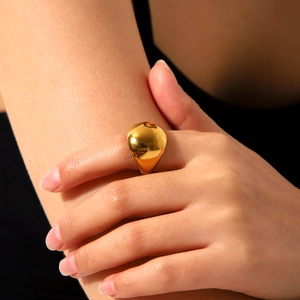 Detailed close-up of a polished gold dome ring showing its smooth rounded surface