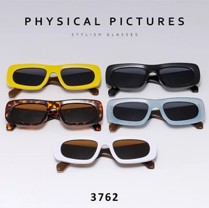 Flat lay of five retro narrow rectangular sunglasses in various colors and glossy finish