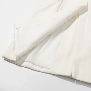Detail of white wool blend coat showing high-quality fabric texture and smooth inner lining