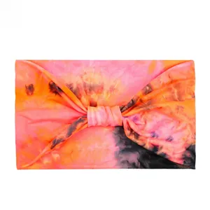 Detail of a pink and orange tie-dye knot headband made from high-elastic knit fabric