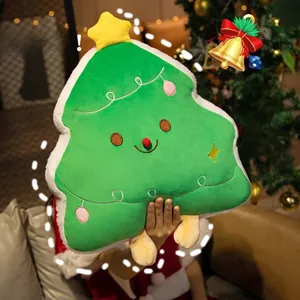Close-up of plush green Christmas tree pillow with star, embroidery and soft fleece trim