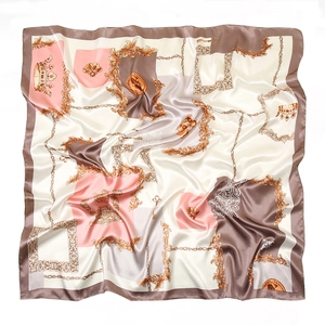 Detailed view of silk square scarf featuring gold chain and baroque crown patterns