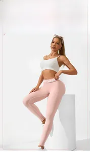 Detailed macro view of high-waist yoga leggings featuring Fitness text and breathable mesh fabric