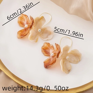 Detail view of vintage amber flower earrings with pearls and marble petals