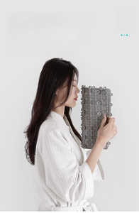 Detail of gray non-slip TPE bathroom mat showing flexible grid structure and odor-free material