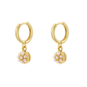 Detail shot of golden circular hoop earrings with pearl-inlaid round heart pendants