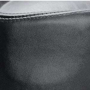 Macro view of high-quality black PU leather texture and fine stitching on the fedora hat