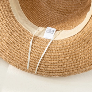 Detail view of the 100% paper straw hat interior featuring an adjustable inner sweatband