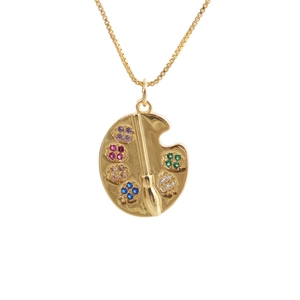 Detail of gold artist palette pendant with colorful zircons and paintbrush