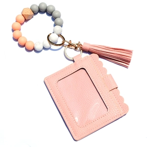 Pink silicone bead wristlet with PU leather card holder and tassel keychain charm