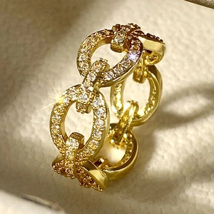 Macro view of gold chain link ring with pavé-set sparkling crystals for women