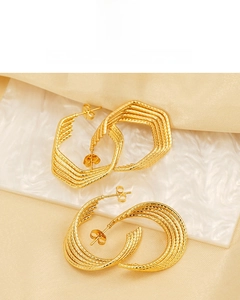 Detail of 18K gold plated U-shaped earrings with textured geometric design and tarnish-resistant finish