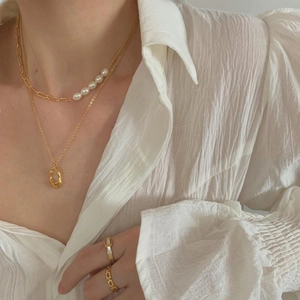 Elegant gold paperclip chain and pearl layered necklace with matching gold rings