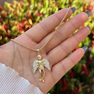 Close-up of hip-hop gold plated angel wings pendant necklace with white zircon stones