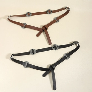 Vintage style brown and black leather belts with carved metal buckle and knot design