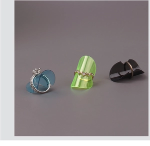 Detailed view of translucent blue, green, and black plastic ring adjusters on various rings