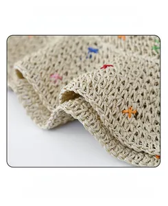 Detail of straw hat texture with rainbow stitching and internal adjustable strap
