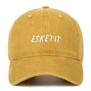 Close-up of ESKETIT white embroidery on a washed ginger cotton baseball cap detail
