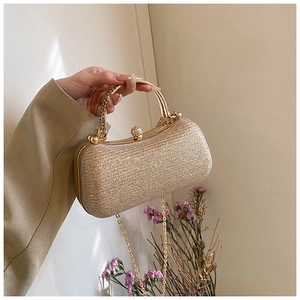 Detail of gold sequin evening clutch bag with crystal sphere clasp and chain handle
