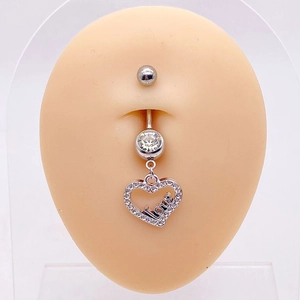 Detail of silver heart belly button ring with rhinestones on a silicone model