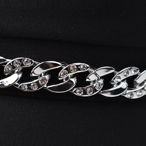 Macro detail of silver metallic chain with rhinestones on a black beret hat