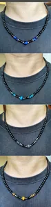 Detail of beaded men's necklaces featuring natural tiger eye stones and black glossy beads