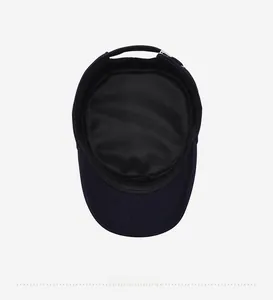 Detail view of the breathable mesh lining and adjustable metal buckle of a flat top cap