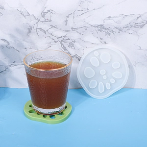 Detail of lotus root silicone mold with a green resin coaster under a water glass
